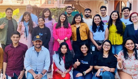A diverse group of Intuit employees posing for a picture.